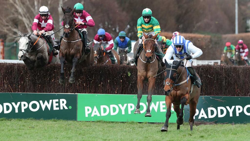Castlebawn West ridden by Paul Townend lands over the last to win The Paddy Power Steeplechase from Minella Times ridden by Rachael Blackmore.