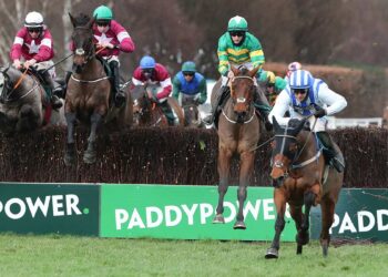 Castlebawn West ridden by Paul Townend lands over the last to win The Paddy Power Steeplechase from Minella Times ridden by Rachael Blackmore.