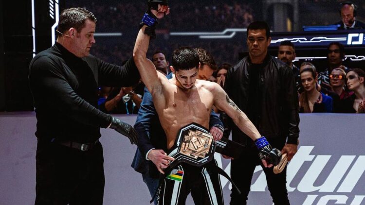 Eoghan Chelmiah has his hand raised by referee Marc Goddard as MMA great Lyoto Machida looks on. Photo: Karate Combat/Instagram