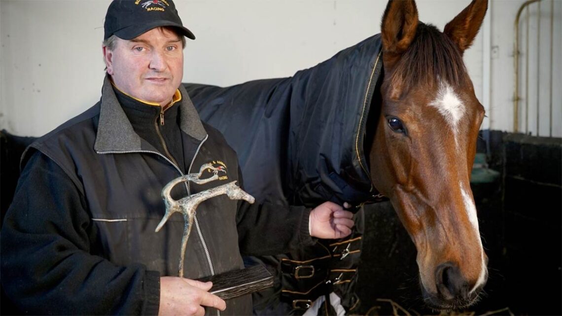 Paul Hennessy with Heaven Help Us and his HRI National Hunt Achievement Award