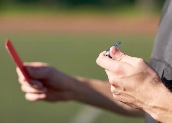 A referee shows a red card. Photo: @dolgachov/Envato