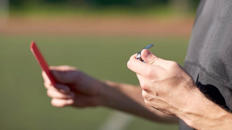 A referee shows a red card. Photo: @dolgachov/Envato