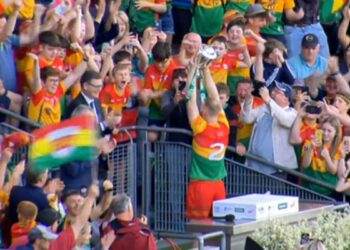 Carlow's Paul Doyle lifts the Joe McDonagh Cup. Screenshot: RTÉ/Twitter