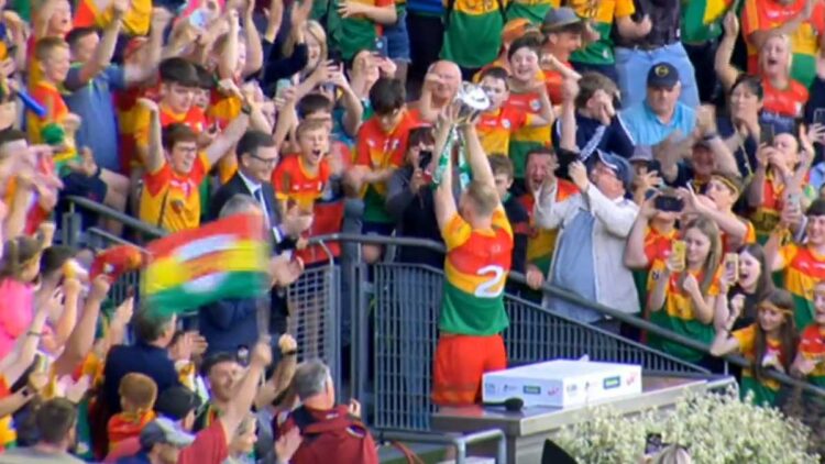 Carlow's Paul Doyle lifts the Joe McDonagh Cup. Screenshot: RTÉ/Twitter